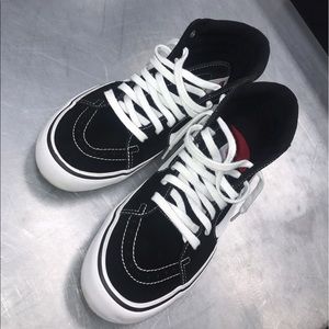 Black and white high top vans